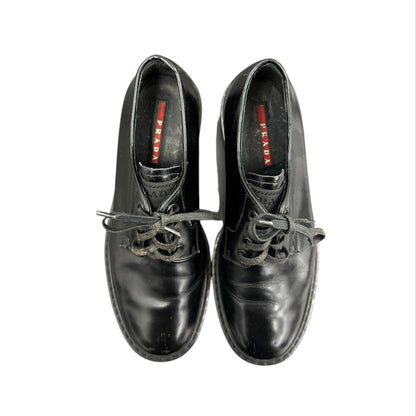 Prada black lace-up loafers