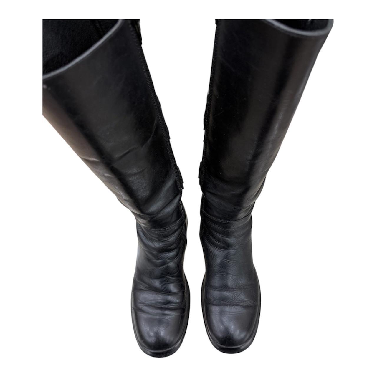Knee-high leather boots with straps