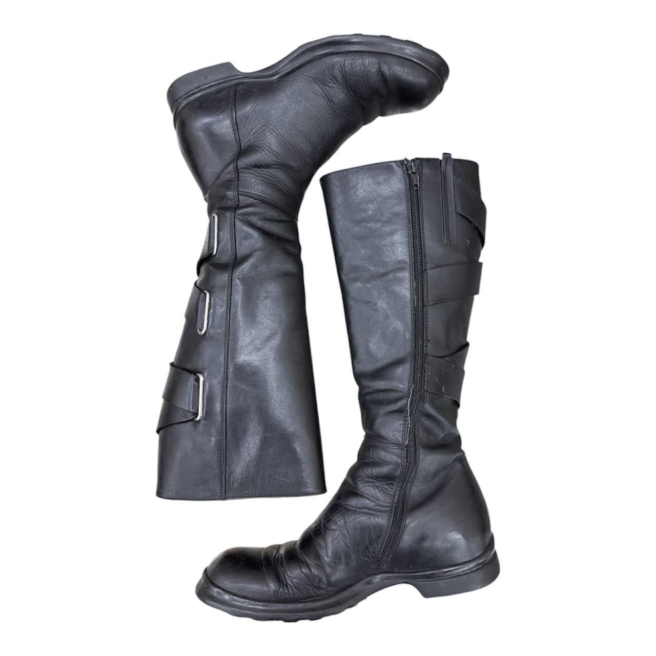 Knee-high leather boots with straps
